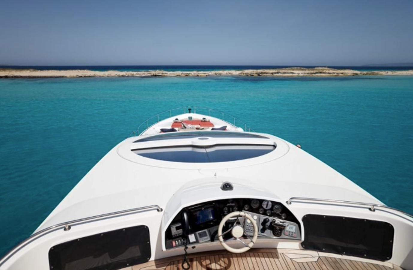 a white yacht on a beach aboard UM7 Yacht for Sale