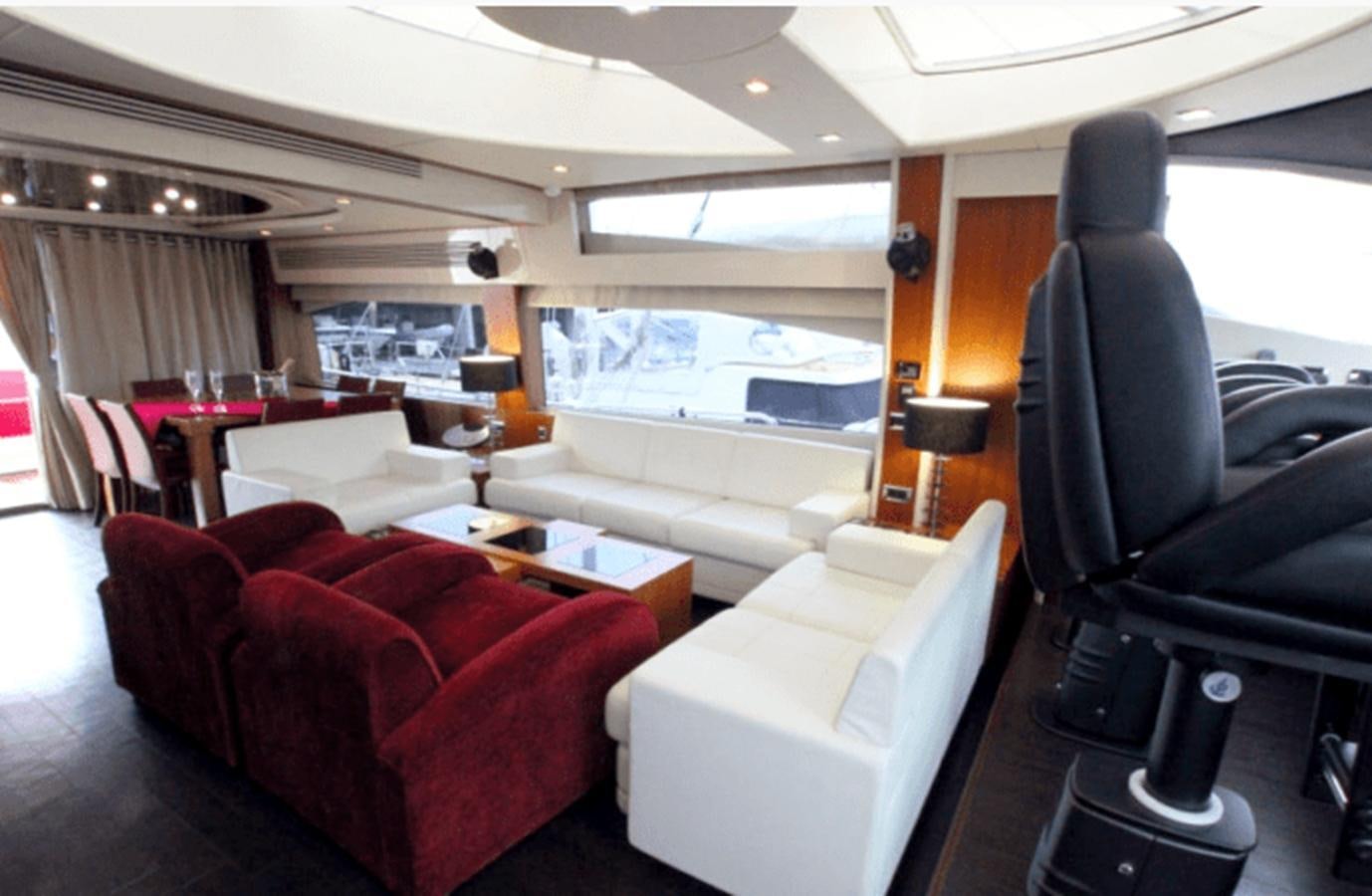 a room with a couch and a table and chairs aboard UM7 Yacht for Sale