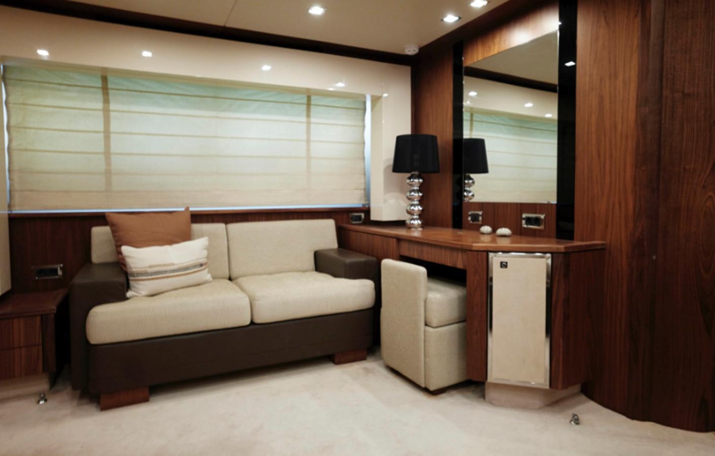 a living room with a couch and a desk aboard UM7 Yacht for Sale