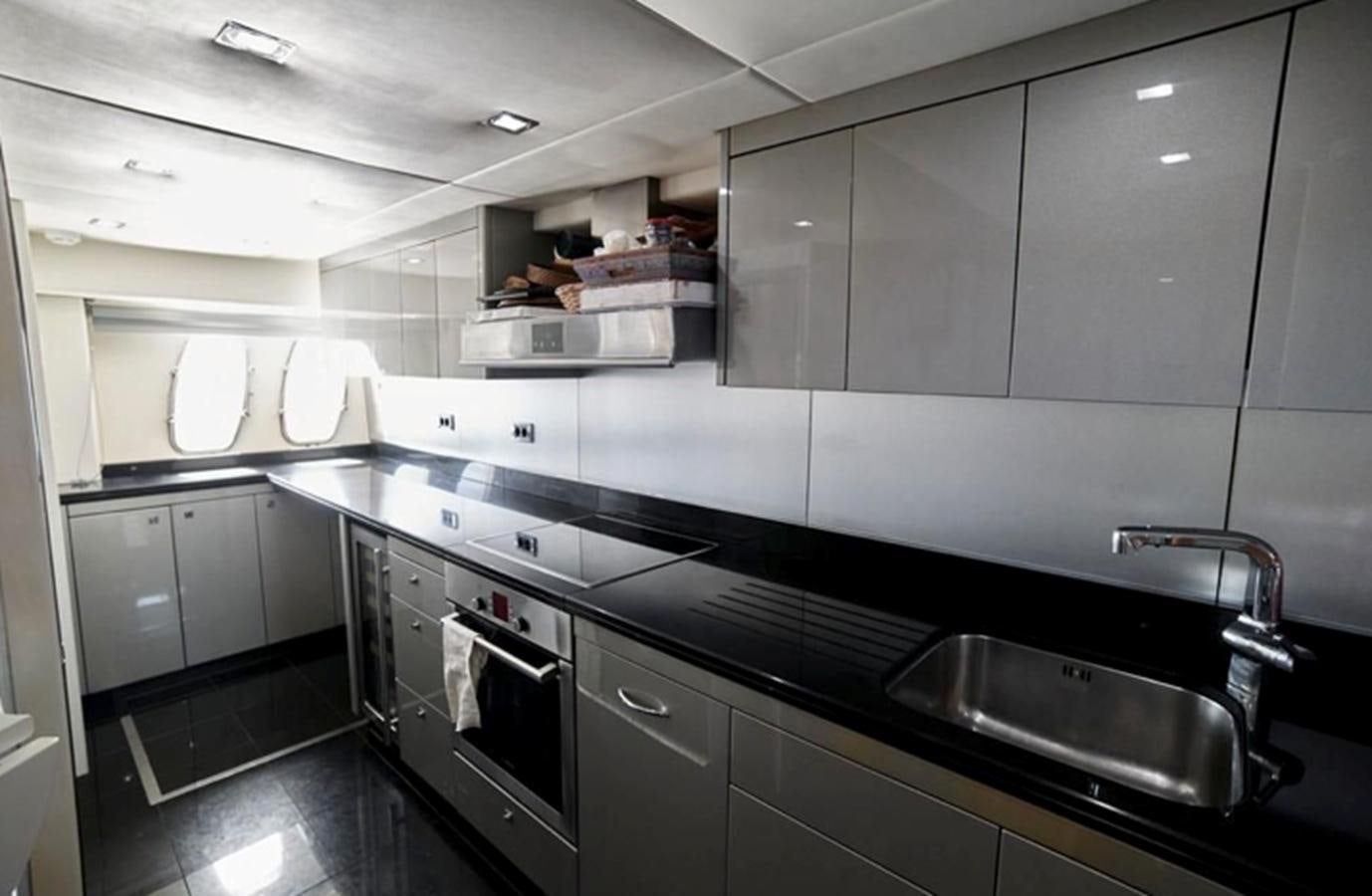 a kitchen with stainless steel appliances aboard UM7 Yacht for Sale