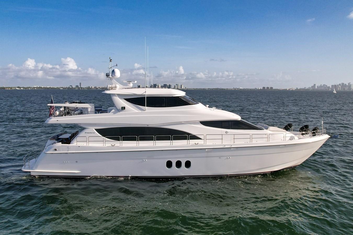a white yacht in the water aboard HATTERAS 80 MOTOR Yacht for Sale