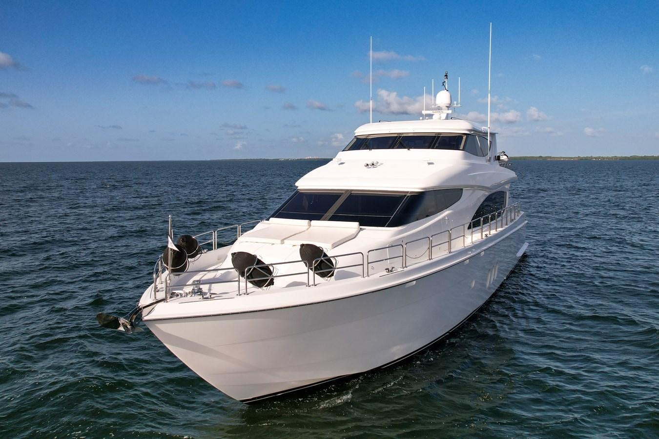 a white yacht in the water aboard HATTERAS 80 MOTOR Yacht for Sale