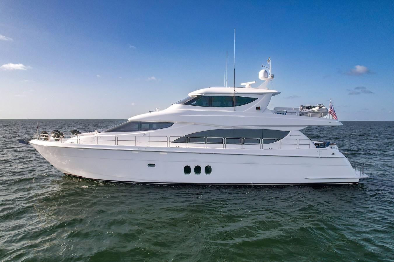 a white yacht in the water aboard HATTERAS 80 MOTOR Yacht for Sale