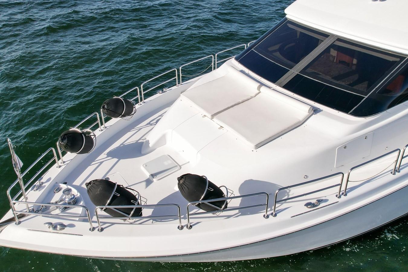 a white boat in the water aboard HATTERAS 80 MOTOR Yacht for Sale
