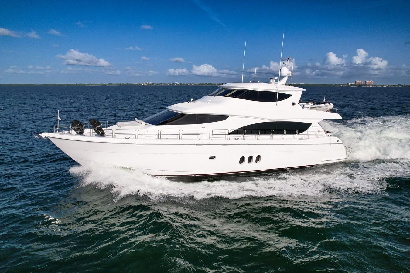 a white boat on the water aboard HATTERAS 80 MOTOR Yacht for Sale