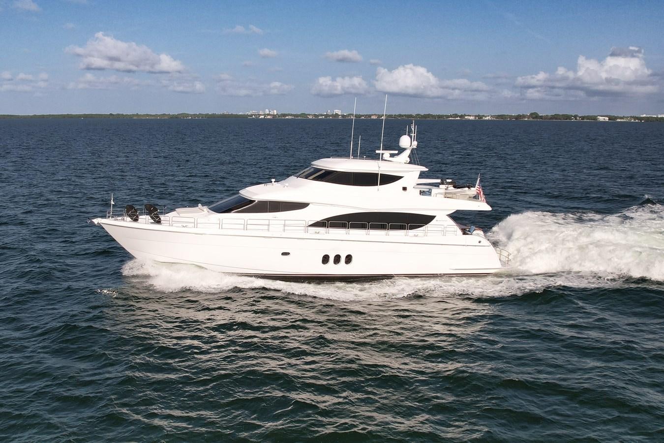 a white boat on the water aboard HATTERAS 80 MOTOR Yacht for Sale