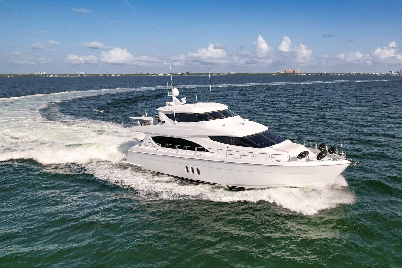 a white yacht in the water aboard HATTERAS 80 MOTOR Yacht for Sale