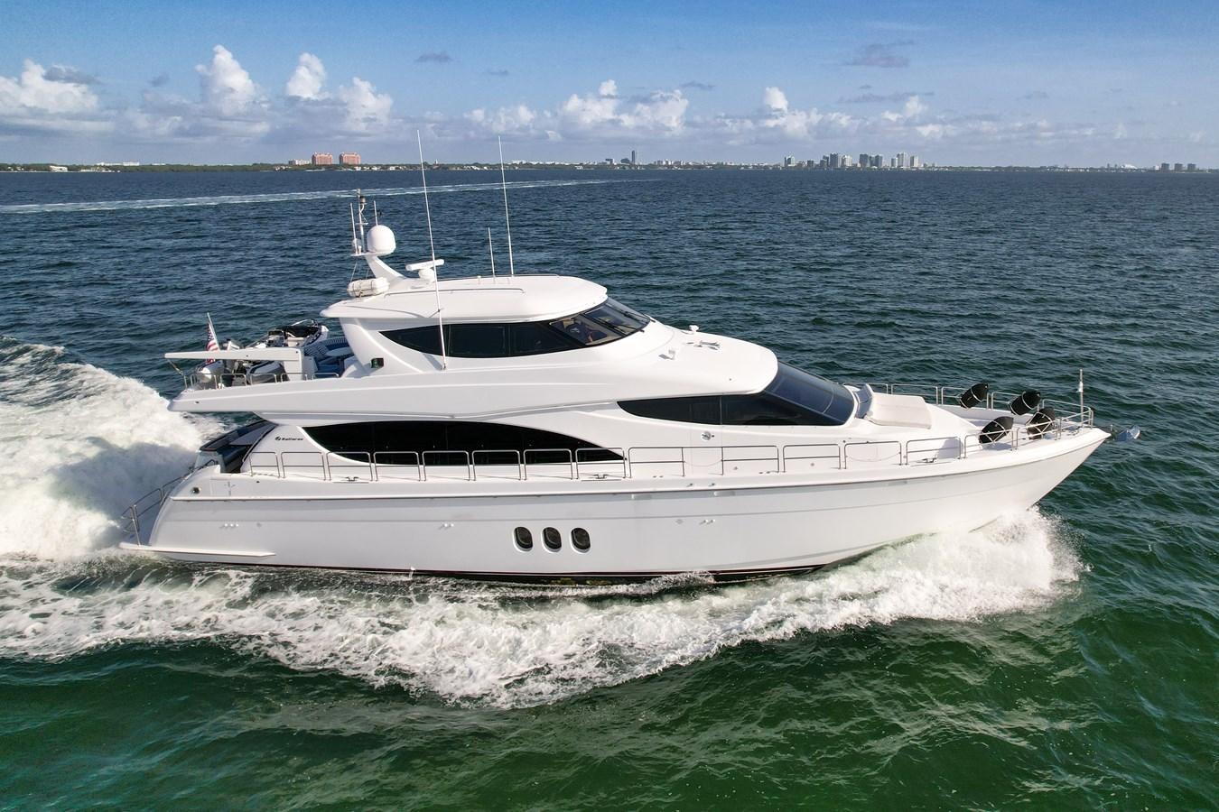 a white yacht in the water aboard HATTERAS 80 MOTOR Yacht for Sale