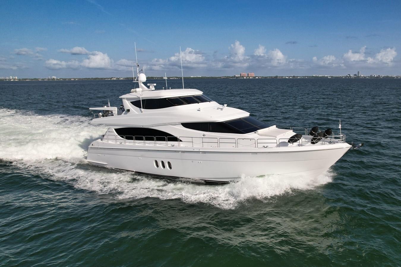 a white yacht in the water aboard HATTERAS 80 MOTOR Yacht for Sale