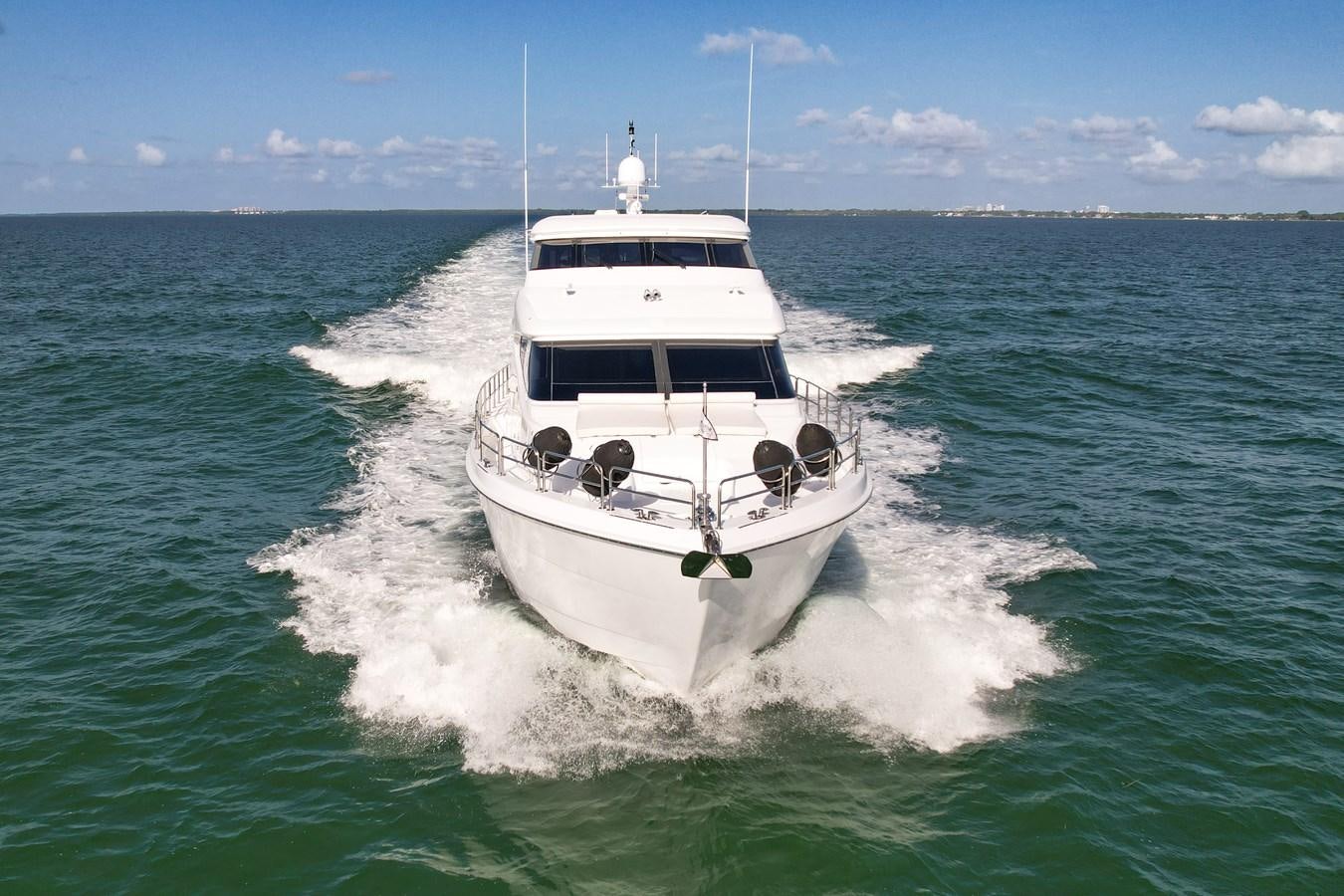 a white boat on the water aboard HATTERAS 80 MOTOR Yacht for Sale
