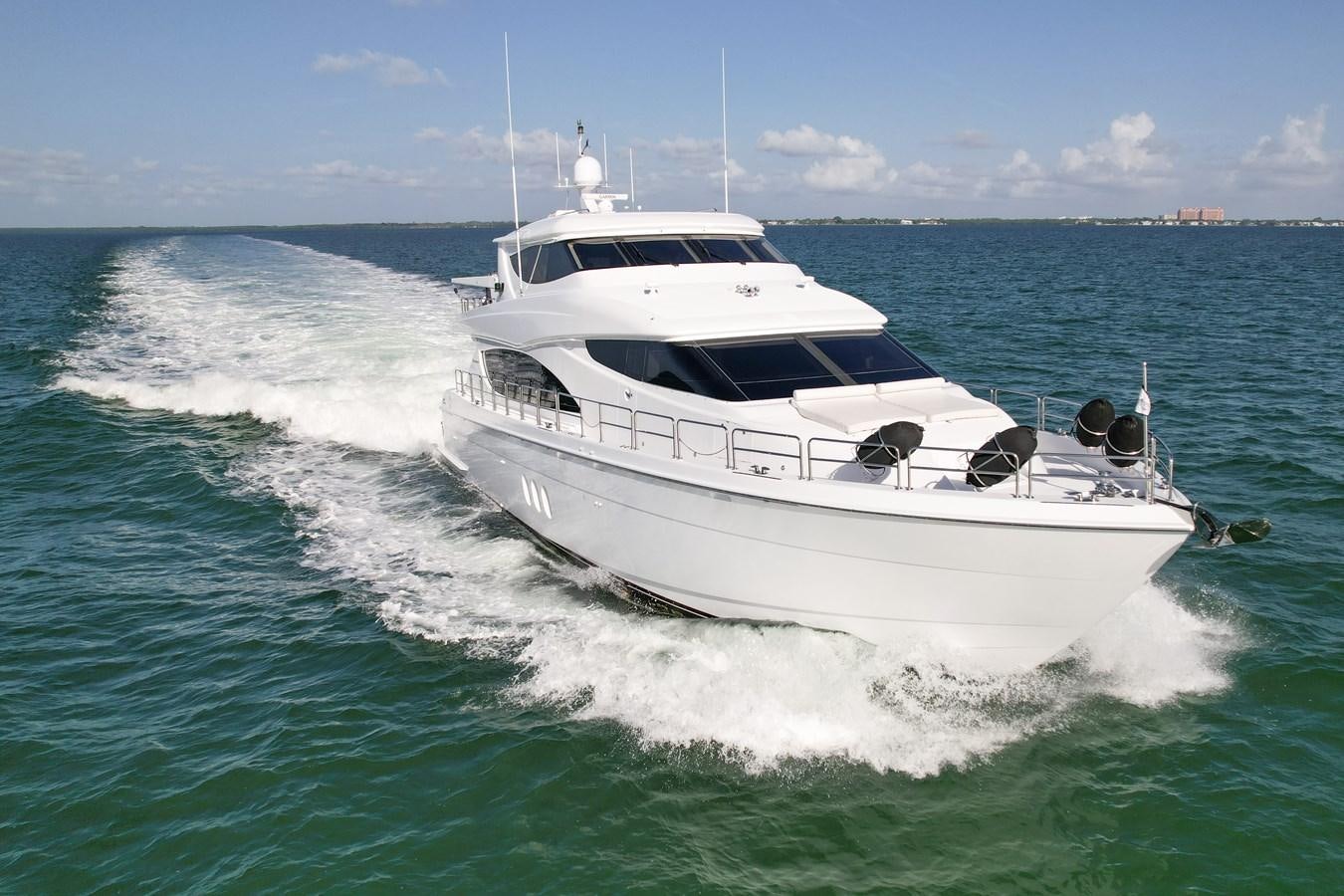 a white yacht on the water aboard HATTERAS 80 MOTOR Yacht for Sale