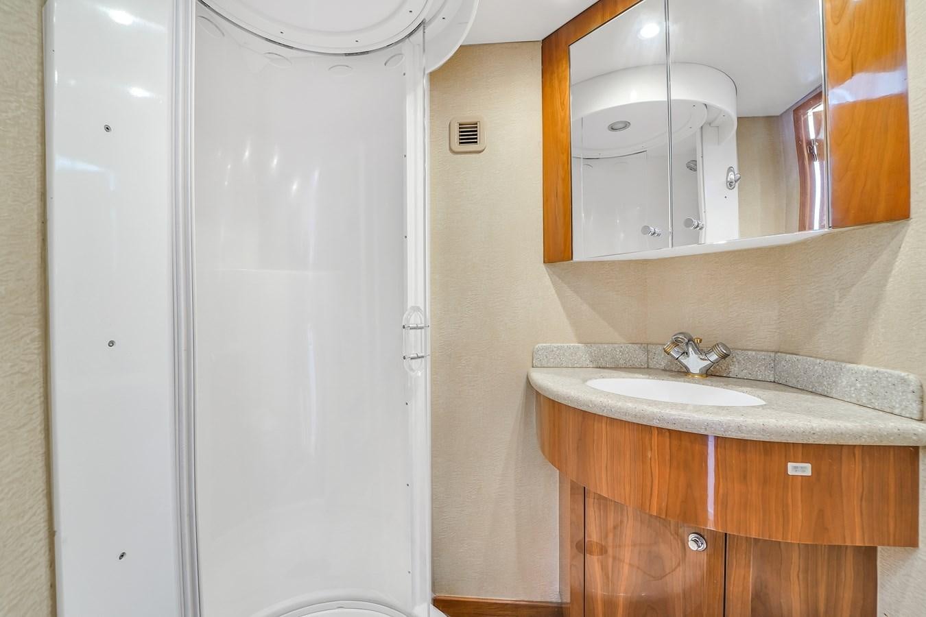 a bathroom with a sink and a mirror aboard HATTERAS 80 MOTOR Yacht for Sale