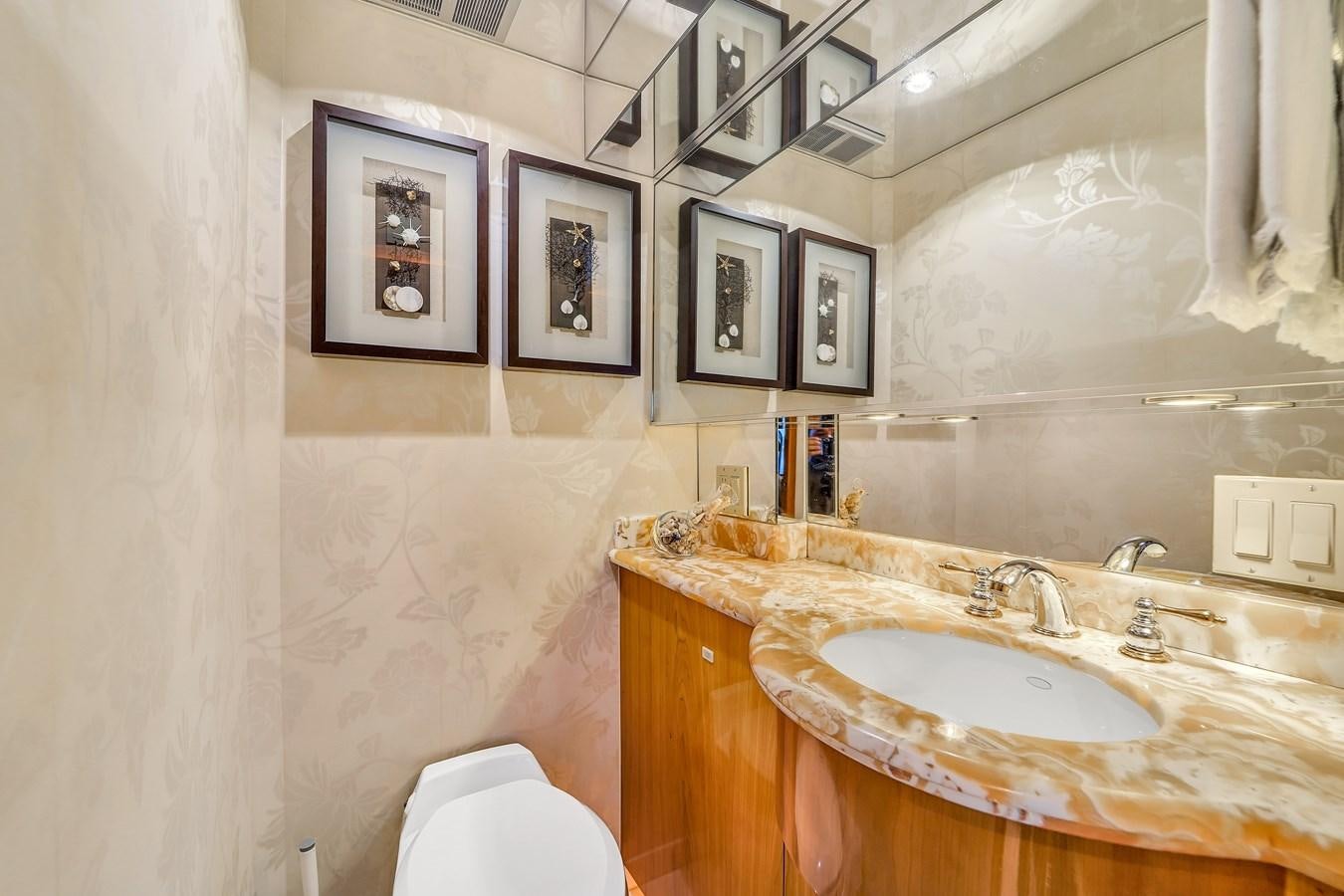 a bathroom with a sink and a mirror aboard HATTERAS 80 MOTOR Yacht for Sale