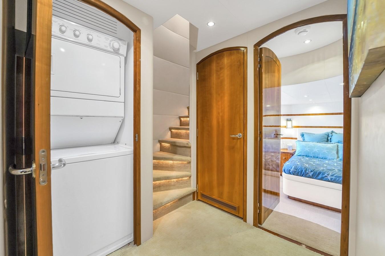 a room with a bed and a closet aboard HATTERAS 80 MOTOR Yacht for Sale