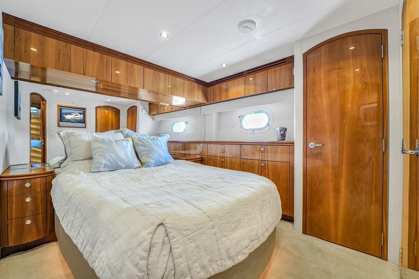 a large bed in a room aboard HATTERAS 80 MOTOR Yacht for Sale