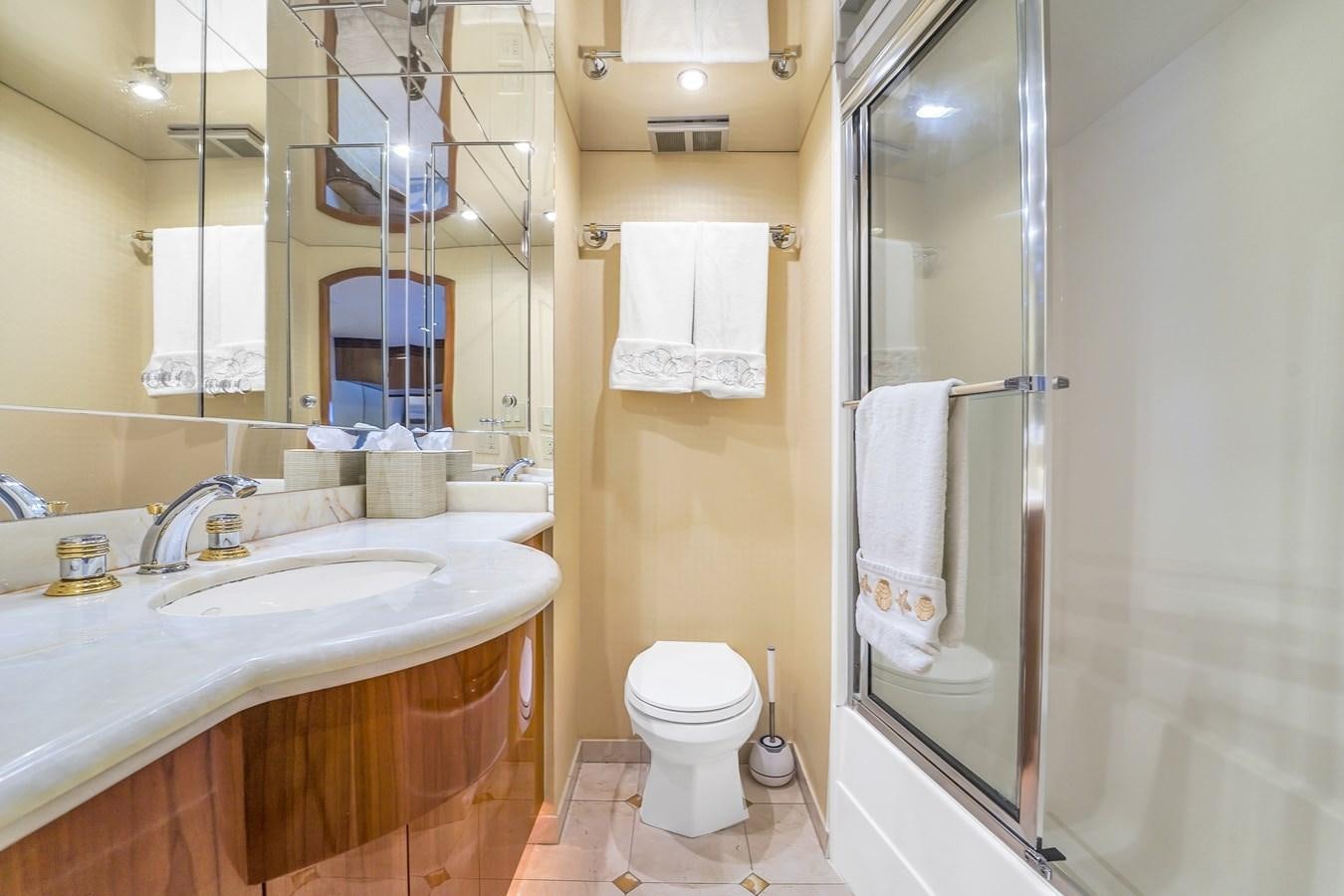 a bathroom with a sink toilet and a shower unit aboard HATTERAS 80 MOTOR Yacht for Sale