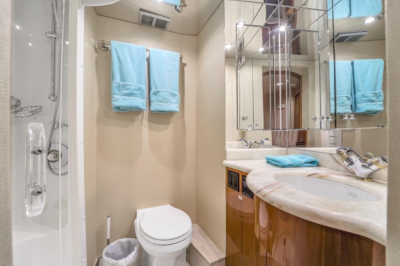 a bathroom with a sink and a toilet aboard HATTERAS 80 MOTOR Yacht for Sale