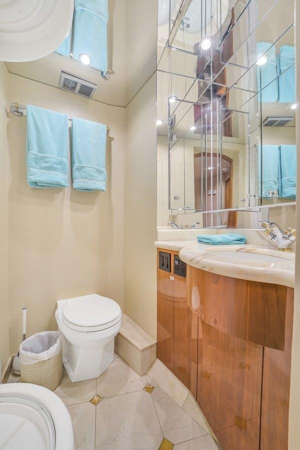 a bathroom with a toilet and a sink aboard HATTERAS 80 MOTOR Yacht for Sale