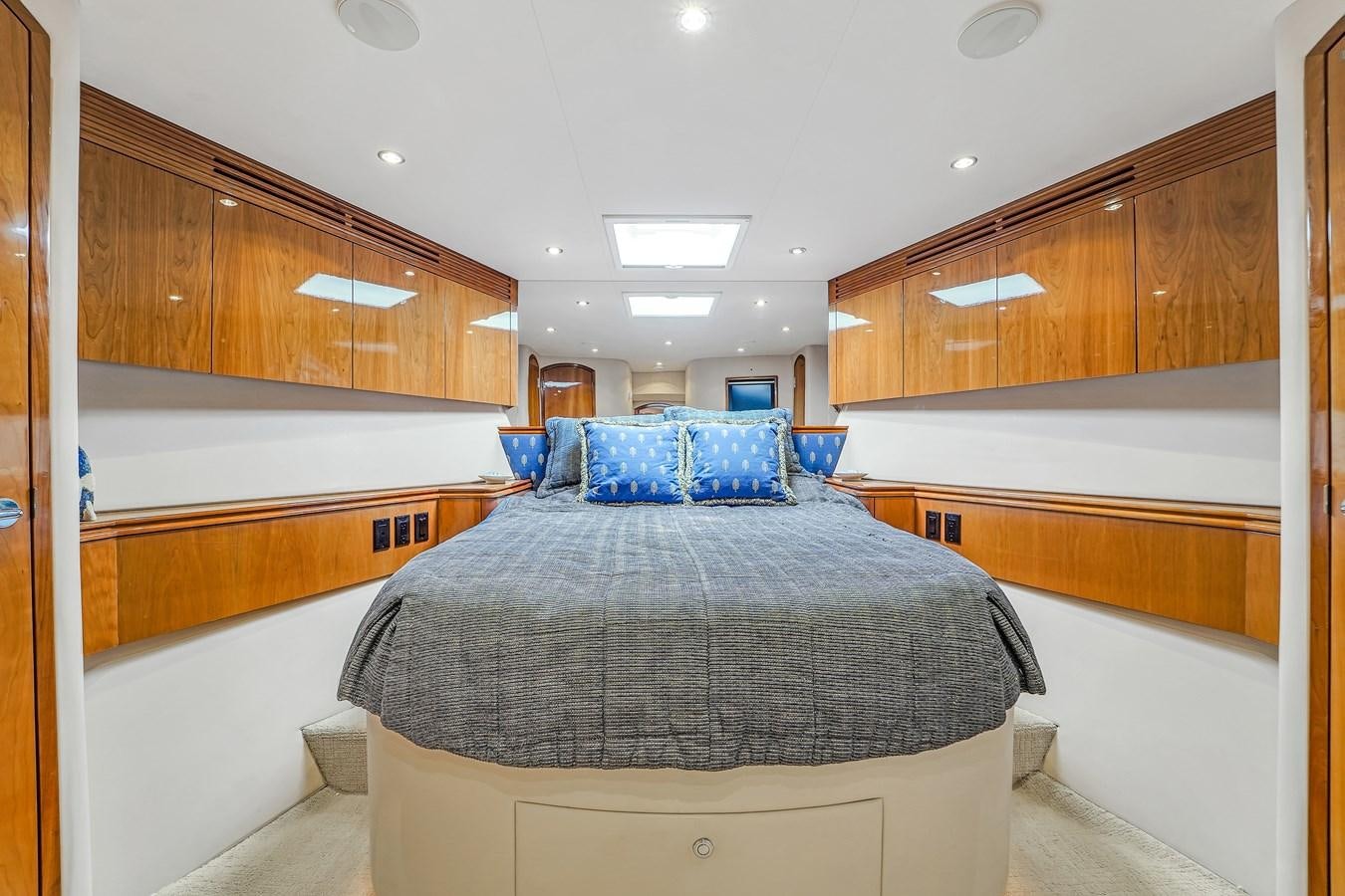 a bedroom with a bed aboard HATTERAS 80 MOTOR Yacht for Sale