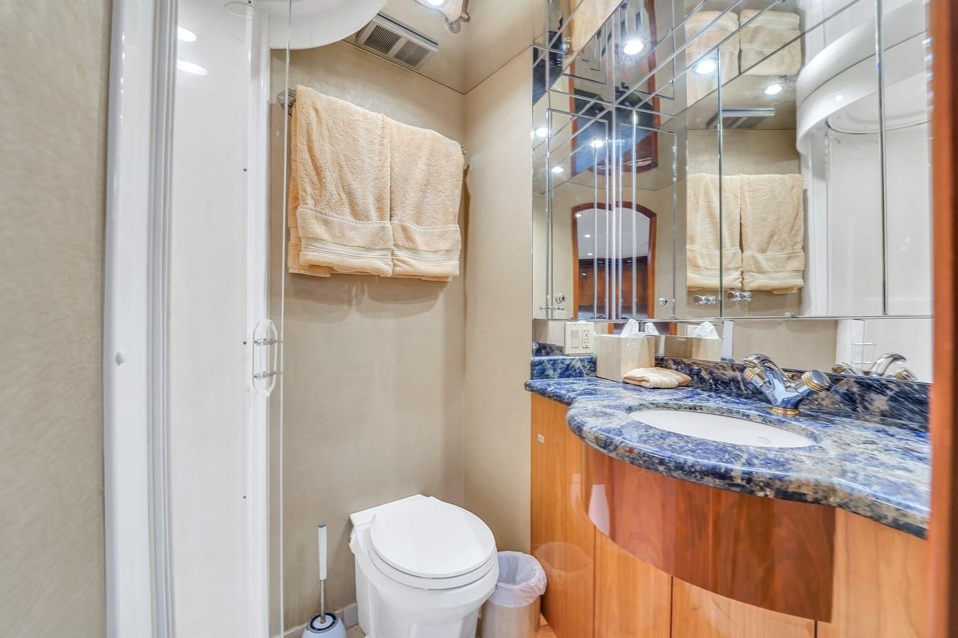 a bathroom with a sink and toilet aboard HATTERAS 80 MOTOR Yacht for Sale