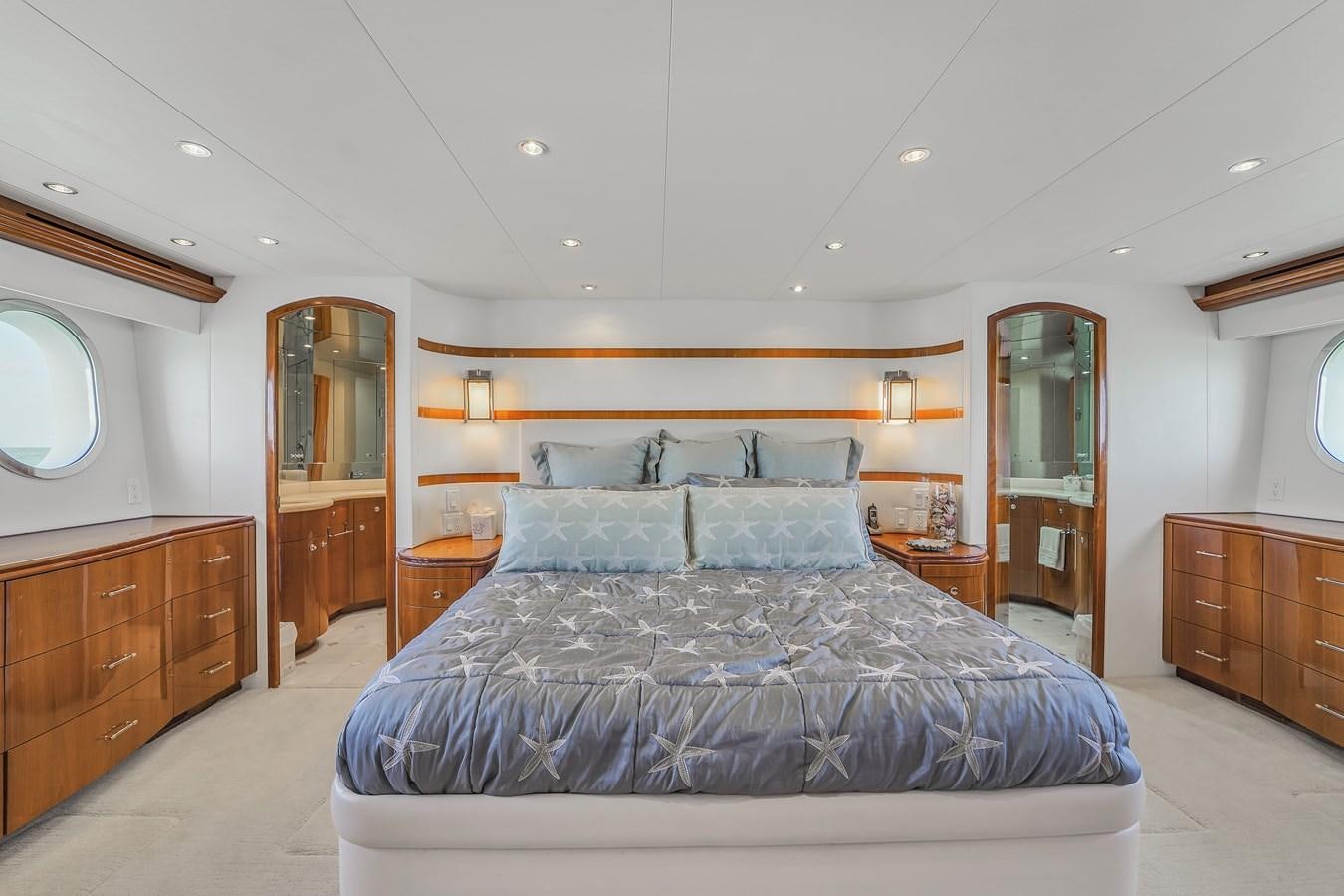 a large bedroom with a bed aboard HATTERAS 80 MOTOR Yacht for Sale