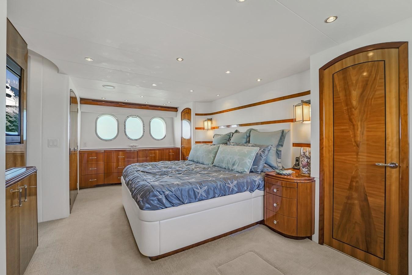 a bedroom with a bed and a closet aboard HATTERAS 80 MOTOR Yacht for Sale
