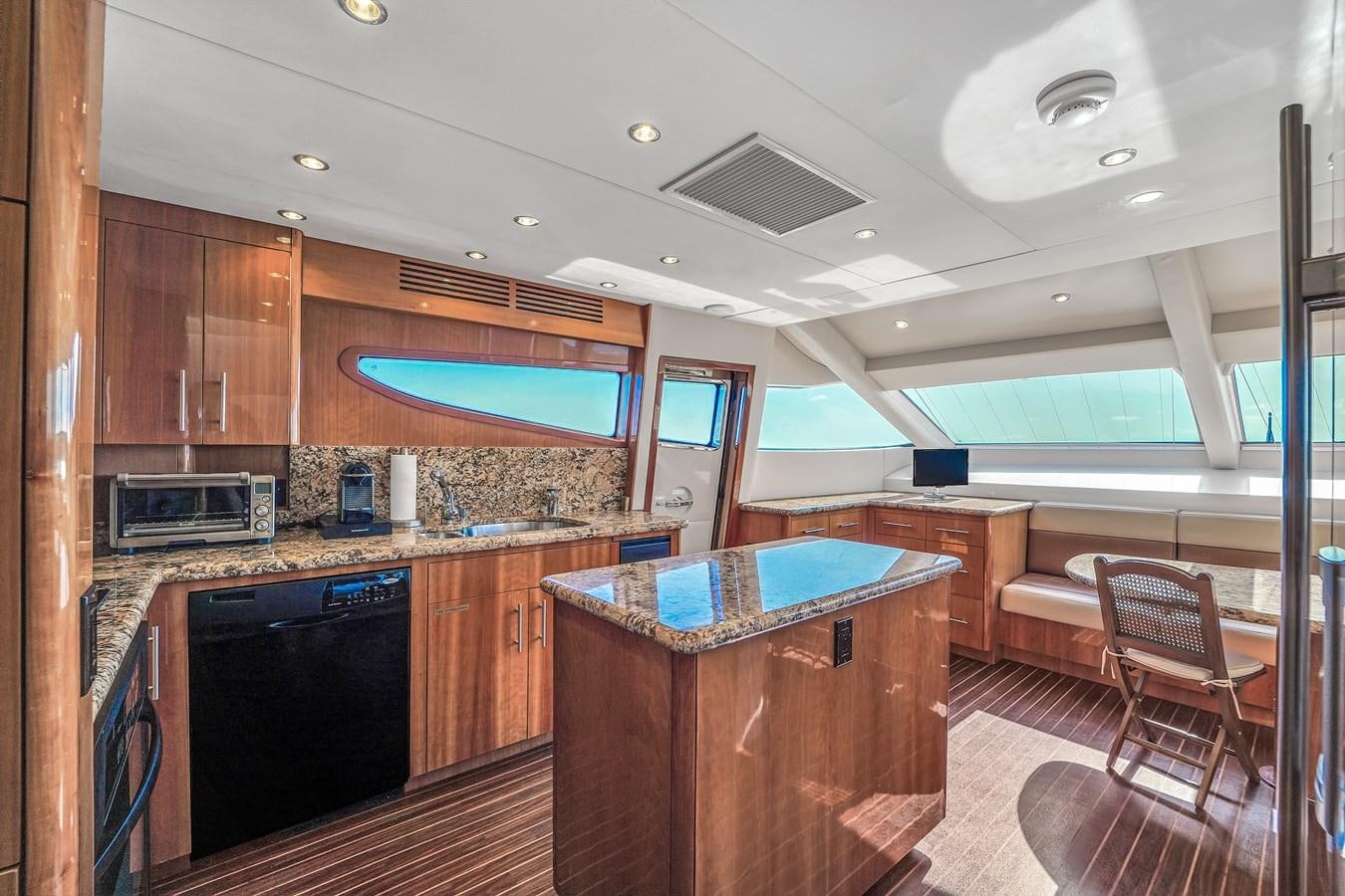 a kitchen with wooden cabinets aboard HATTERAS 80 MOTOR Yacht for Sale