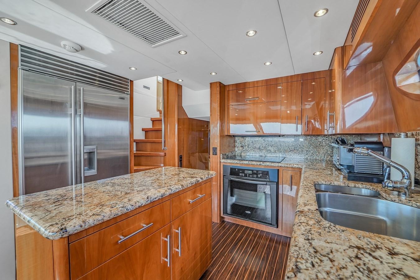 a kitchen with stainless steel appliances aboard HATTERAS 80 MOTOR Yacht for Sale
