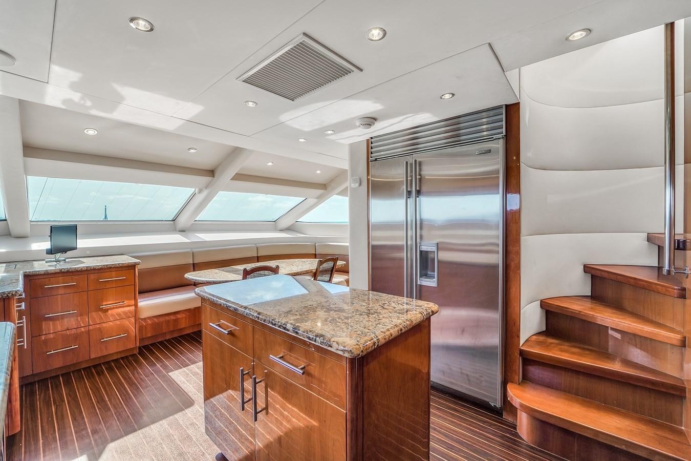 a large kitchen with a refrigerator aboard HATTERAS 80 MOTOR Yacht for Sale