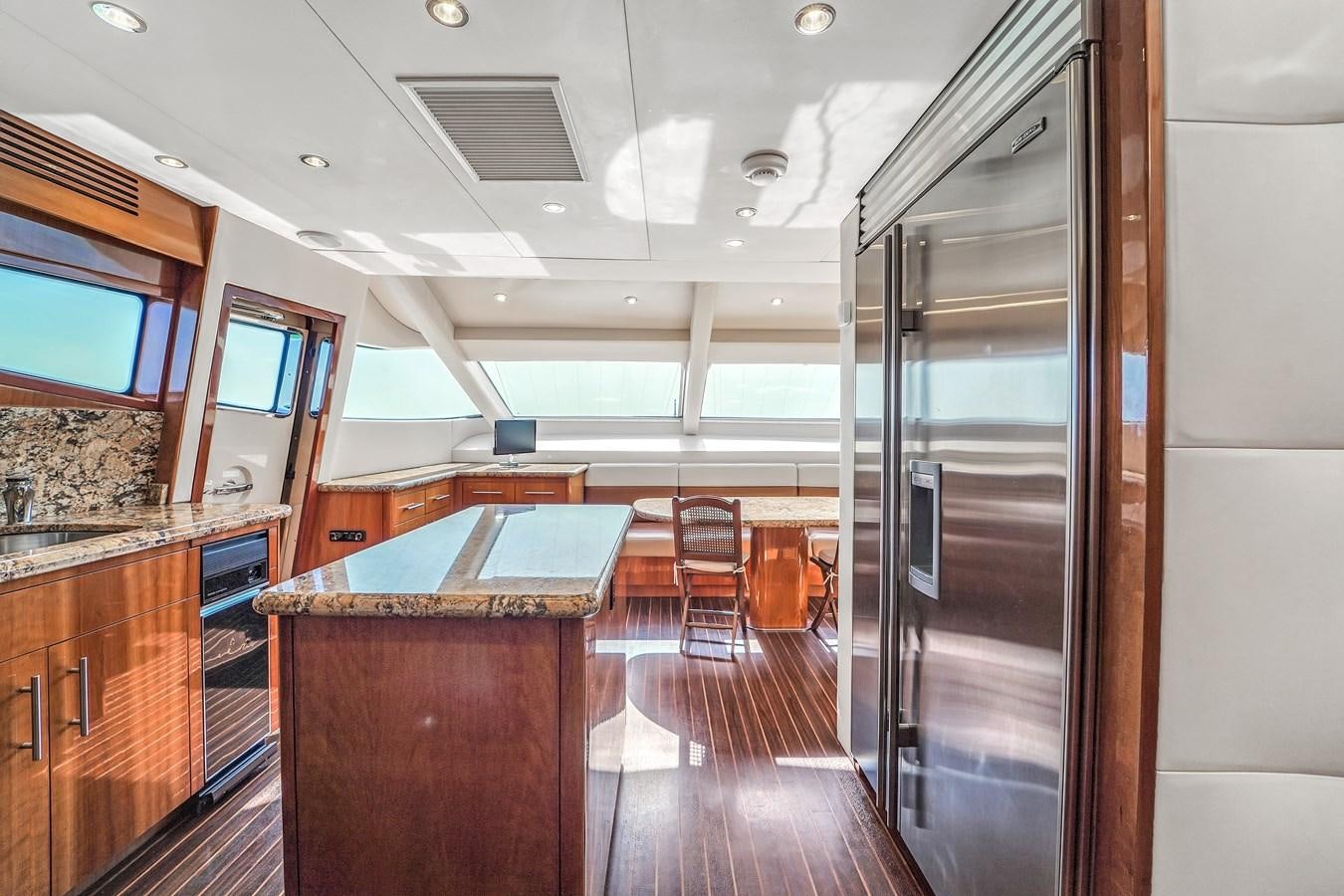 a kitchen with a large glass door aboard HATTERAS 80 MOTOR Yacht for Sale
