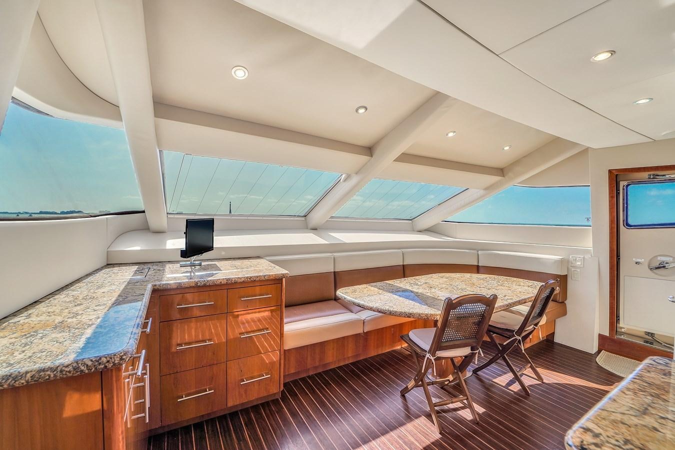 a bedroom with a bed and a desk aboard HATTERAS 80 MOTOR Yacht for Sale