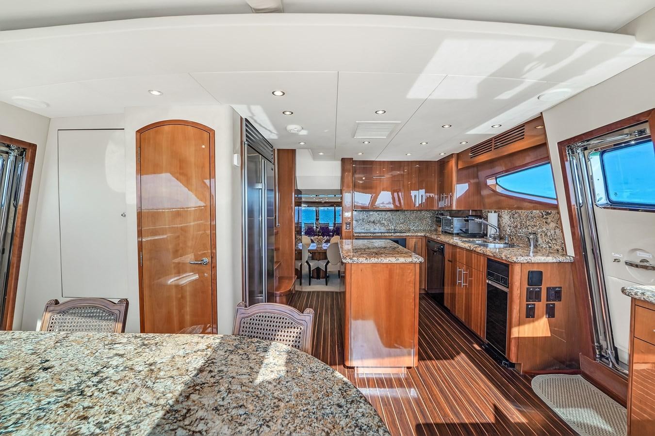 a large room with a bed and a large mirror aboard HATTERAS 80 MOTOR Yacht for Sale