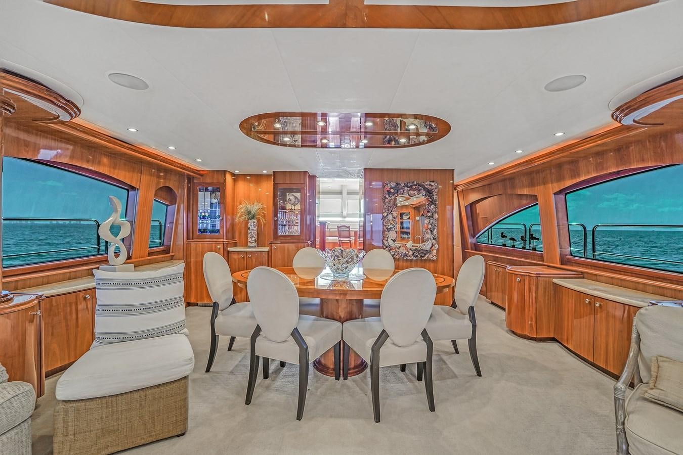 a dining room with a table and chairs aboard HATTERAS 80 MOTOR Yacht for Sale