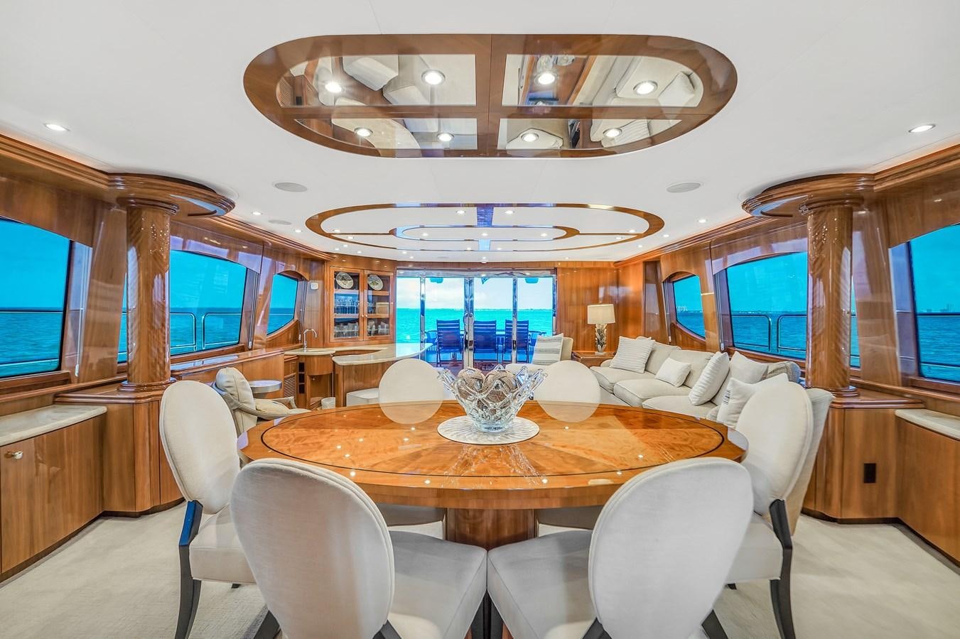 a dining table in a boat aboard HATTERAS 80 MOTOR Yacht for Sale
