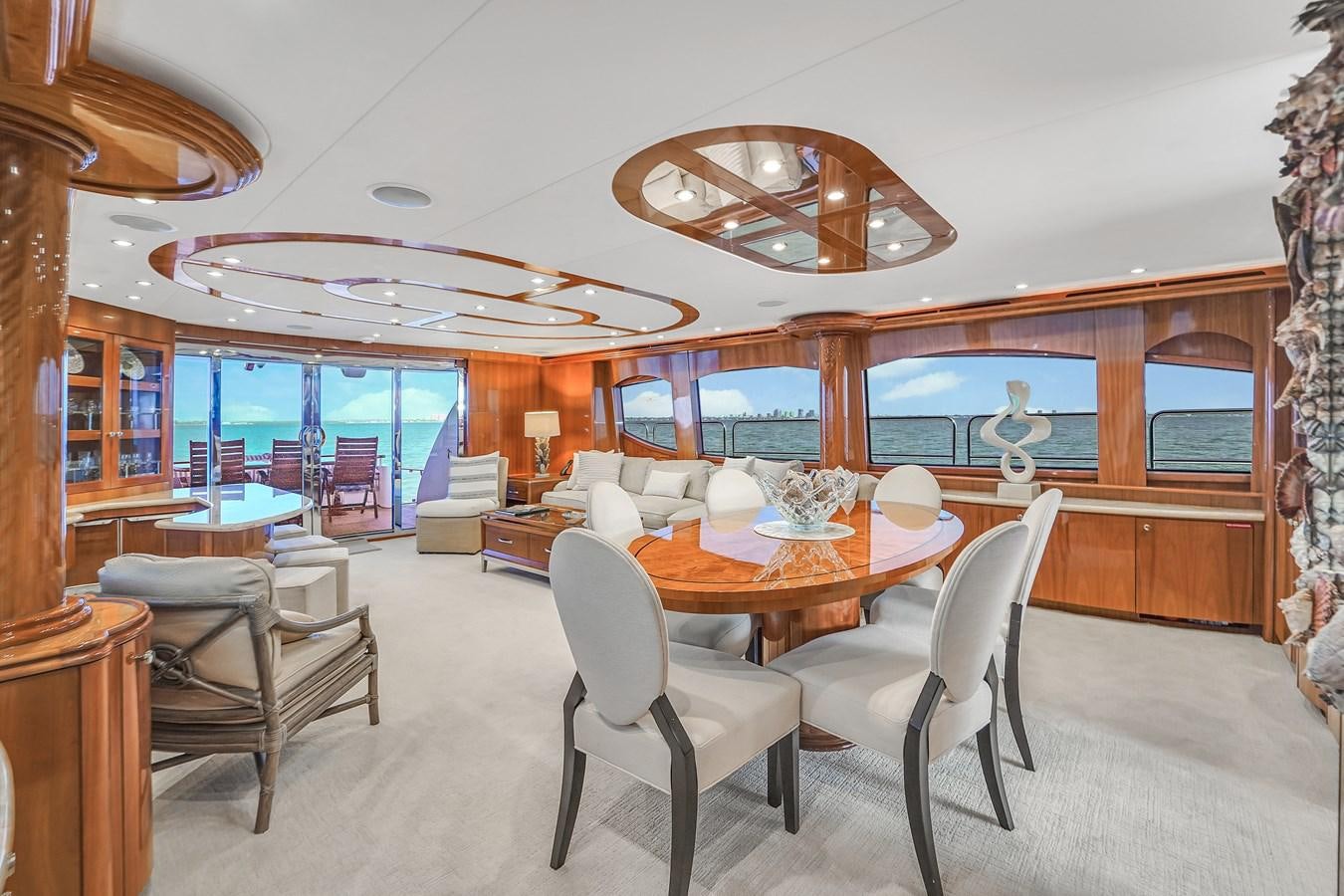 a dining room with a large open floor plan aboard HATTERAS 80 MOTOR Yacht for Sale