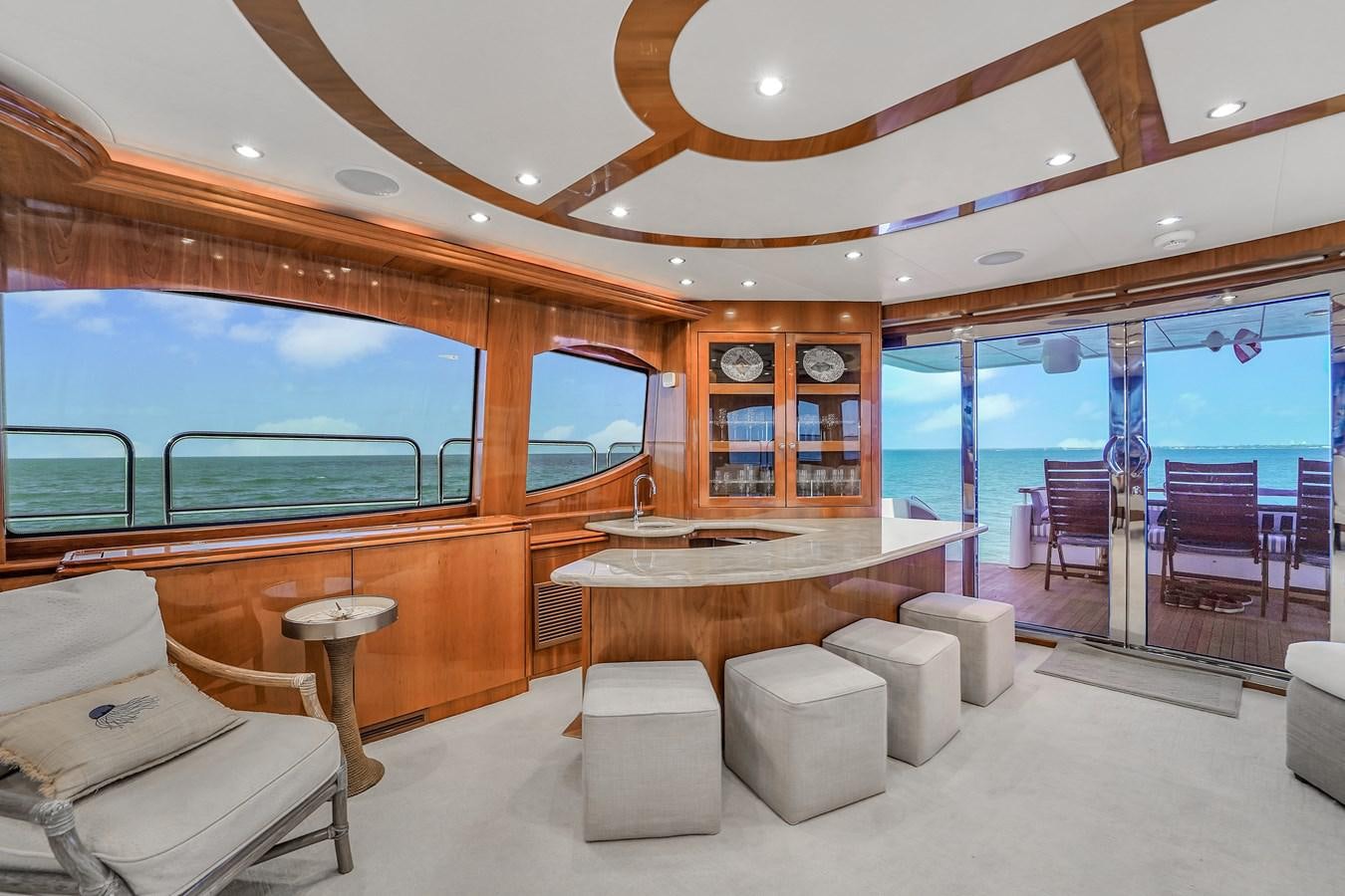 a room with a table and chairs aboard HATTERAS 80 MOTOR Yacht for Sale