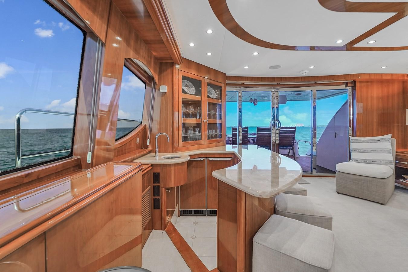 a room with a table and chairs aboard HATTERAS 80 MOTOR Yacht for Sale