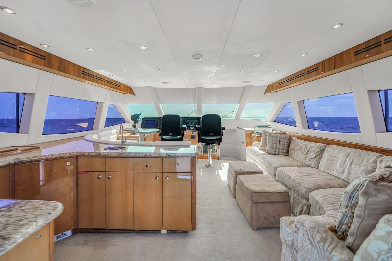 a living room with a couch and a tv aboard HATTERAS 80 MOTOR Yacht for Sale