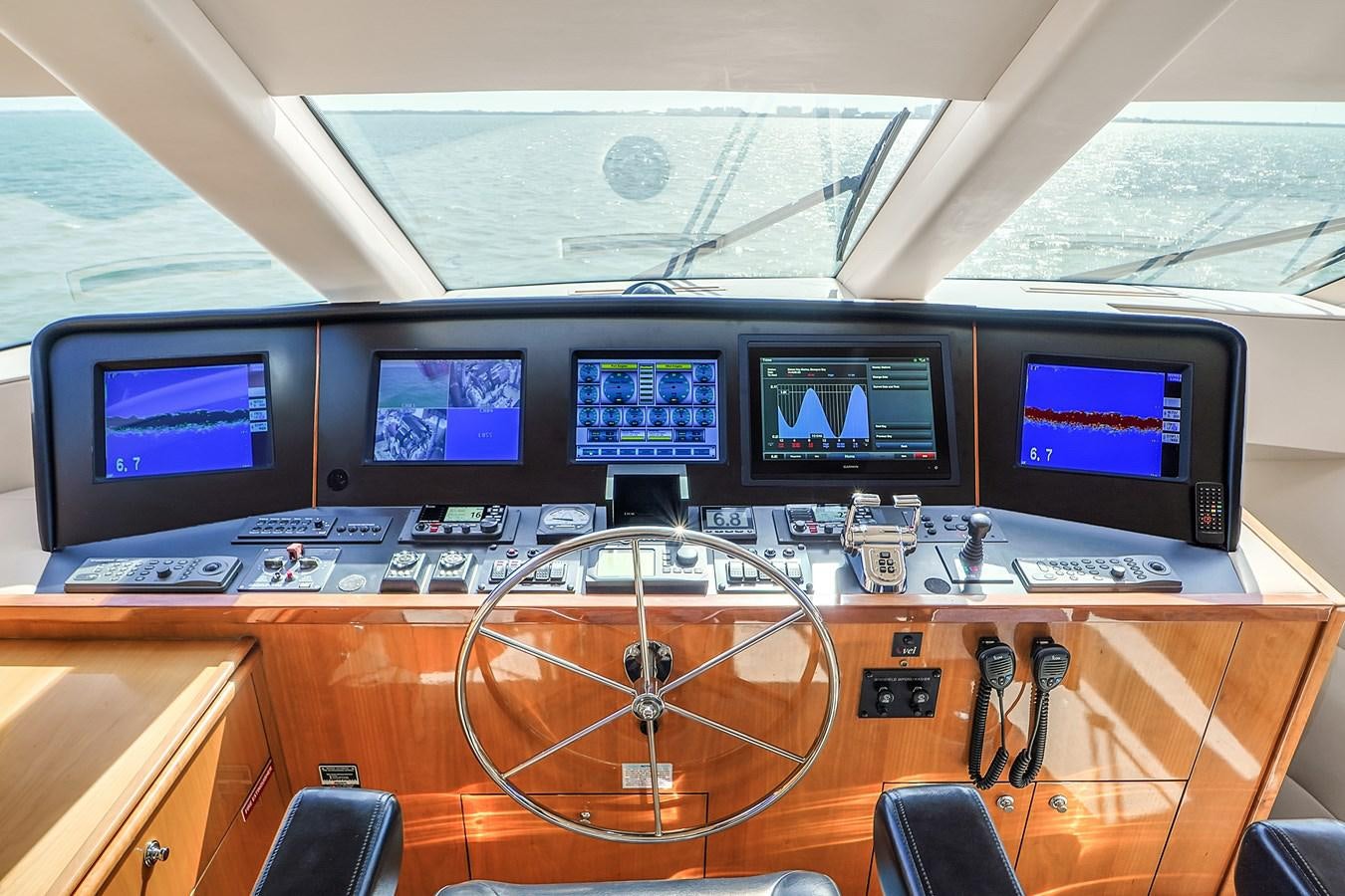 a group of monitors on a table aboard HATTERAS 80 MOTOR Yacht for Sale