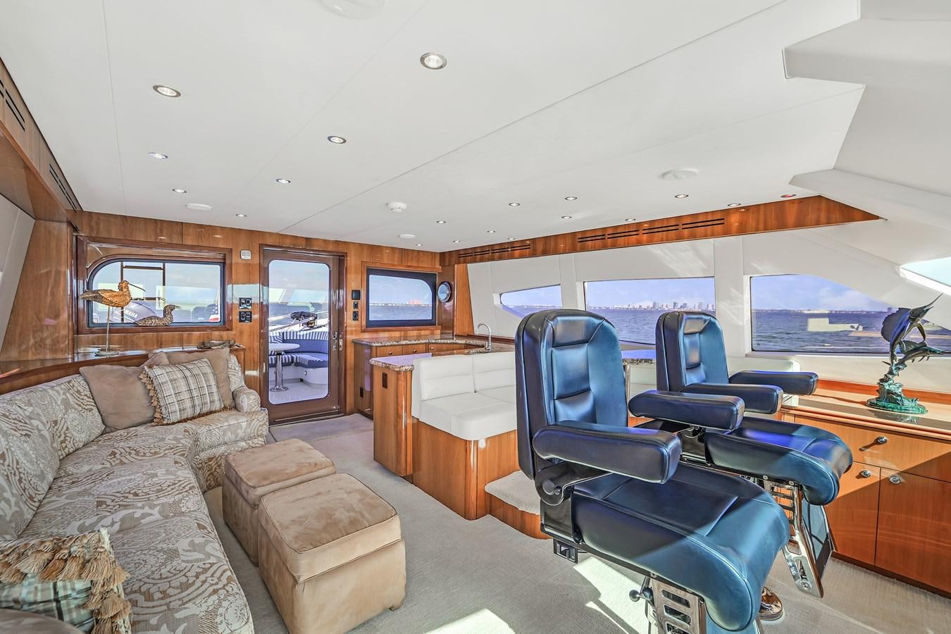 a room with a couch and a bed aboard HATTERAS 80 MOTOR Yacht for Sale