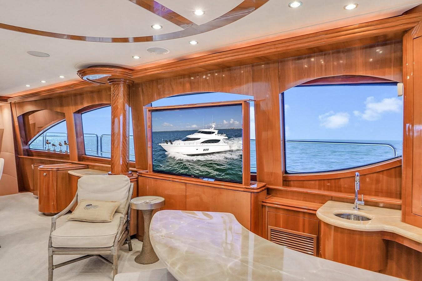 a room with a view of the water and the land below aboard HATTERAS 80 MOTOR Yacht for Sale