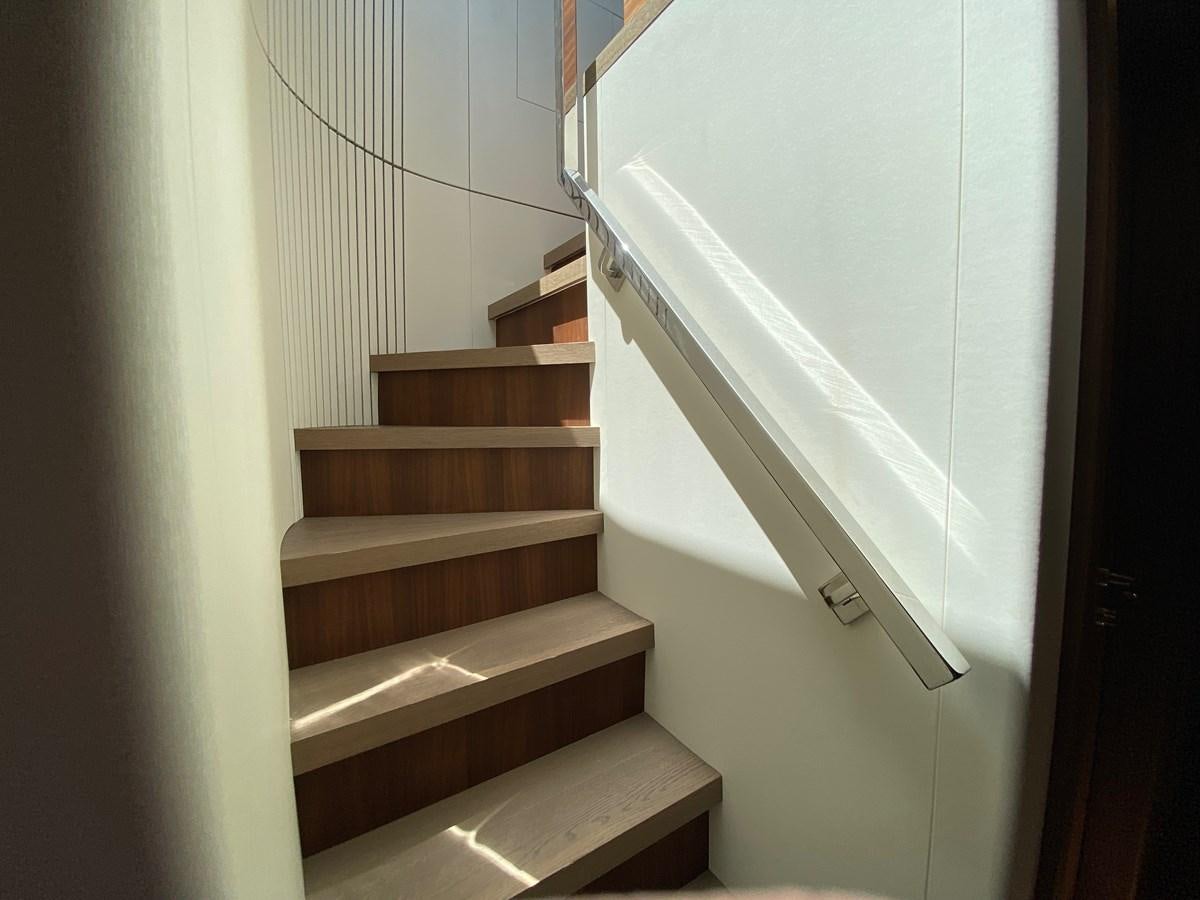a staircase with a white wall aboard CLB 72 Yacht for Sale