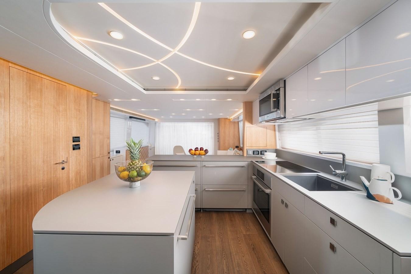 a kitchen with white cabinets aboard CLB 72 Yacht for Sale
