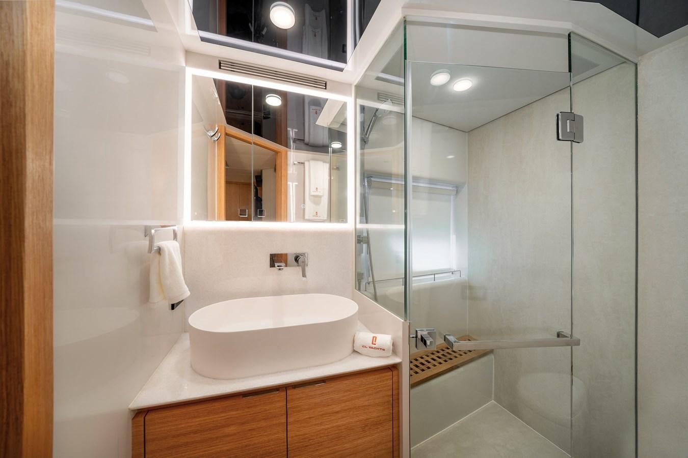 a bathroom with a glass shower aboard CLB 72 Yacht for Sale