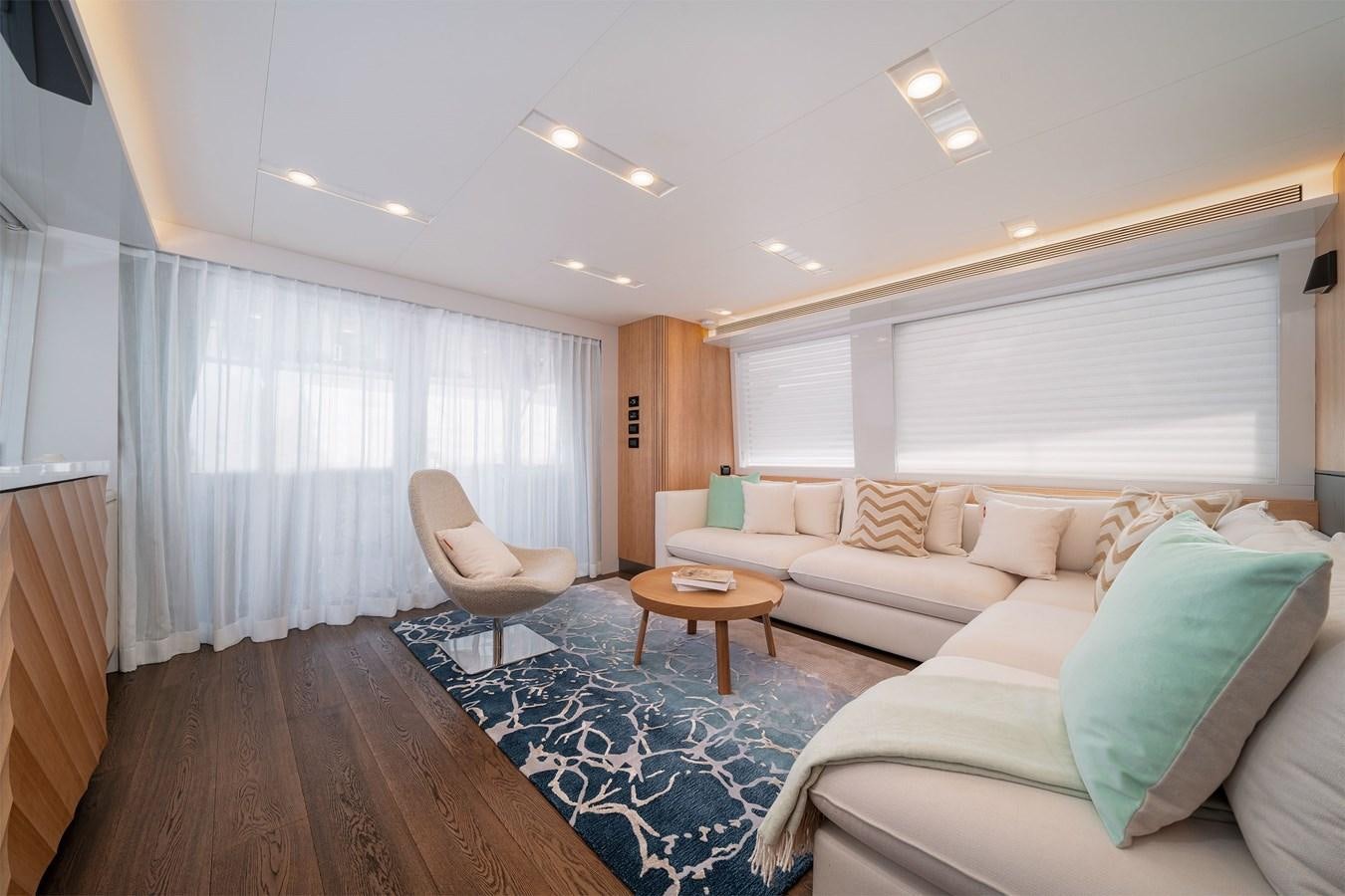 a living room with a couch and a table aboard CLB 72 Yacht for Sale