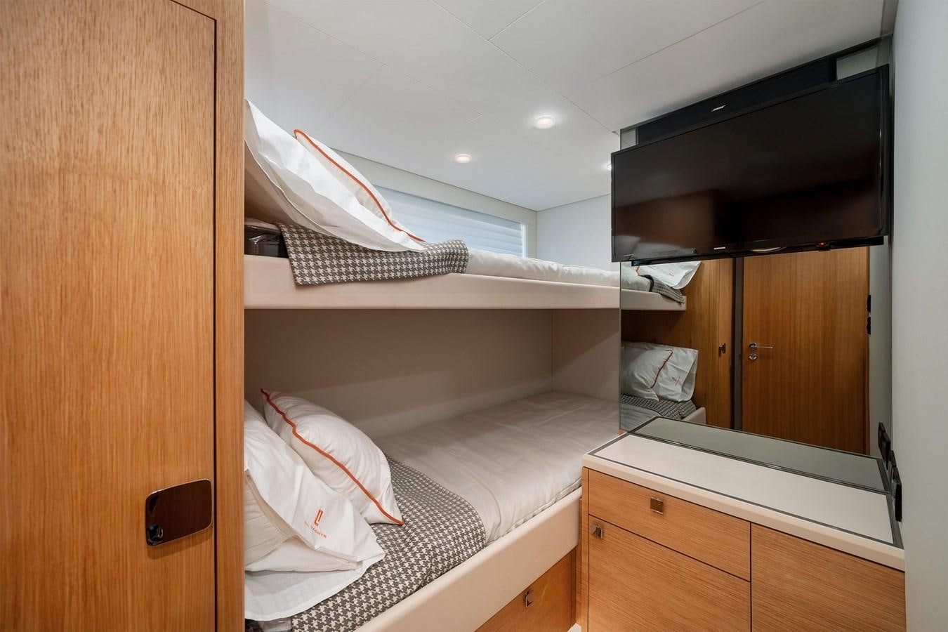 a room with a bed and a television aboard CLB 72 Yacht for Sale