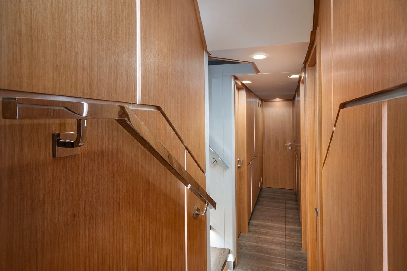 a hallway with wooden cabinets aboard CLB 72 Yacht for Sale