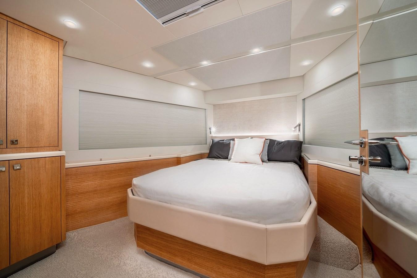 a bedroom with a bed and a closet aboard CLB 72 Yacht for Sale