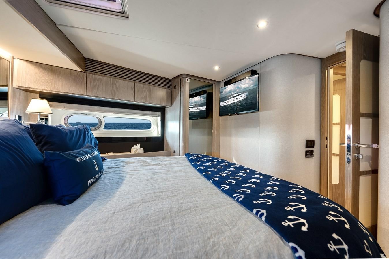 a bed with blue sheets aboard PRODIGALITY 4 Yacht for Sale