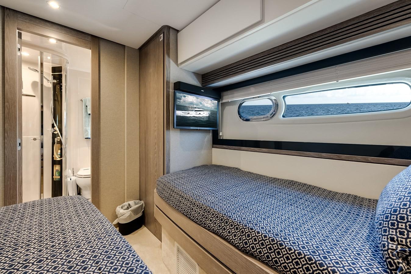 a room with a bed and a television aboard PRODIGALITY 4 Yacht for Sale